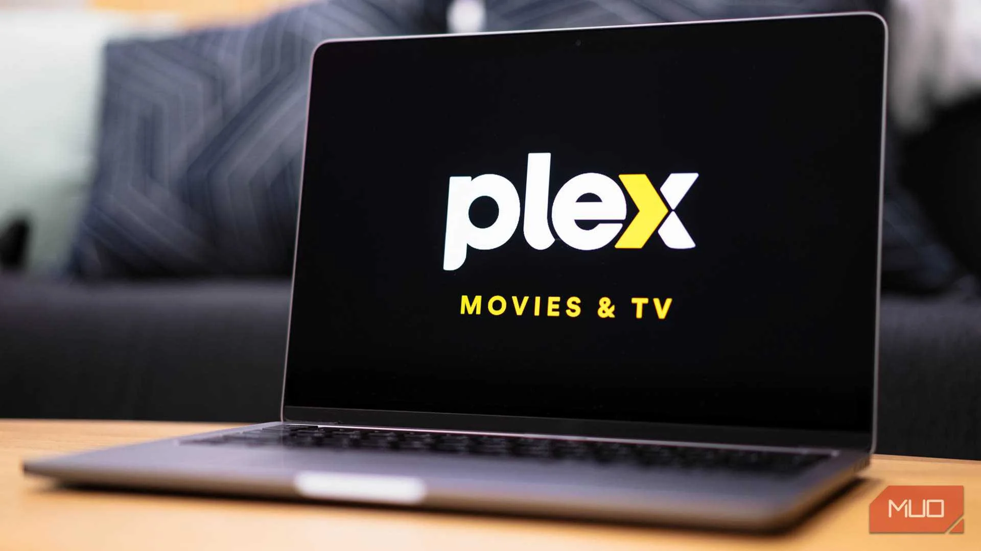 Plex logo displayed on a laptop monitor